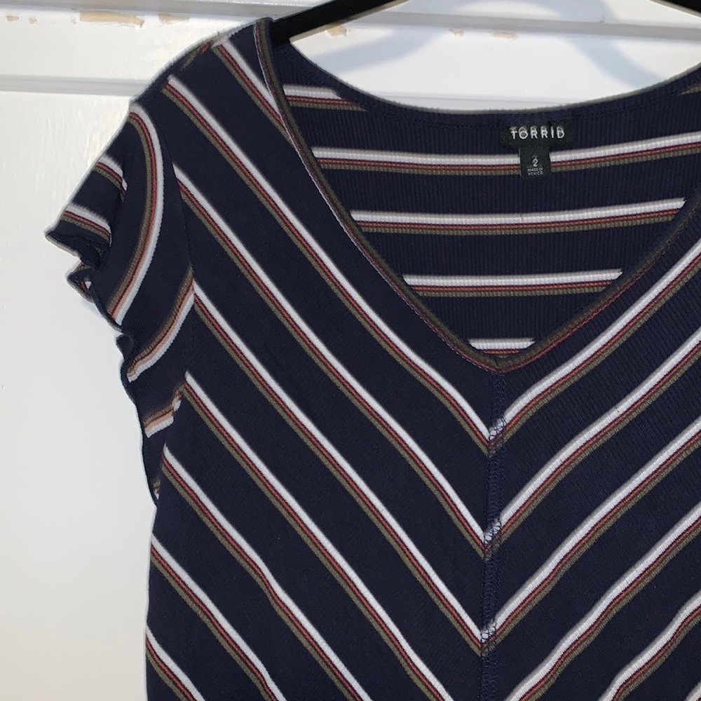 Fitted navy top with white, orange, and green stripes